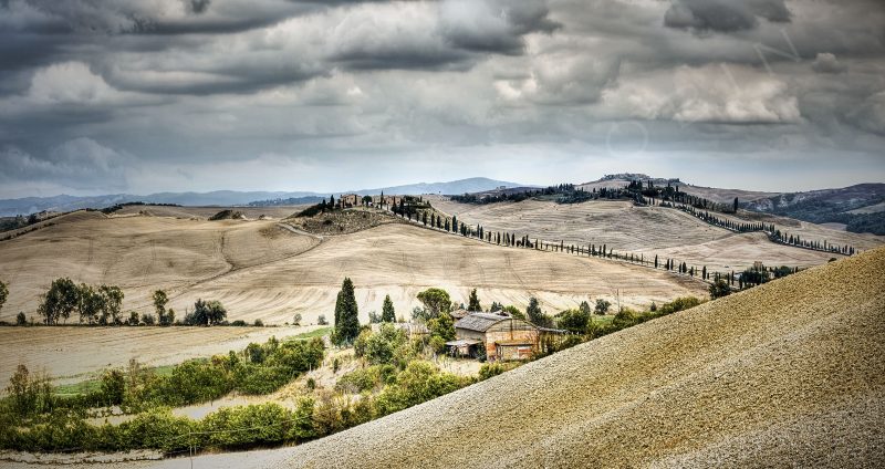 Paysage de Toscane en Italie un jour d'orage avec ses collines et ses ifs